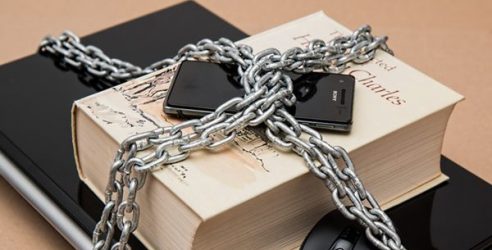 phone on a book padlocked